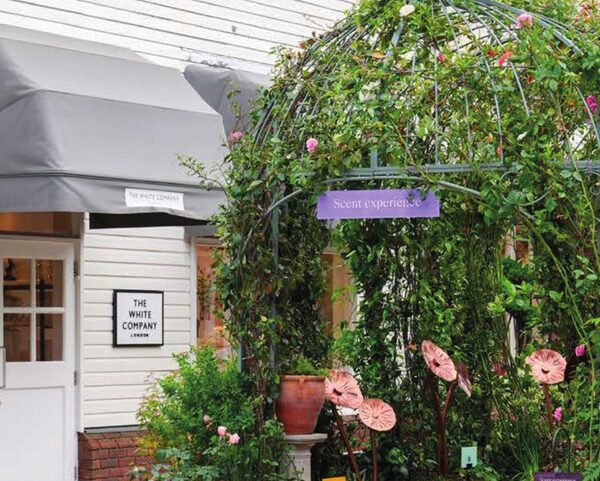 A flower-covered arch in the Bicester Village Summer Garden