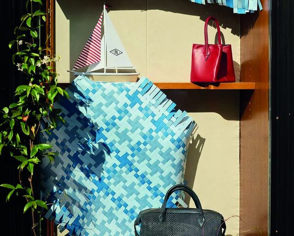 A red M&eacute;tier bag on a shelf in the London flagship